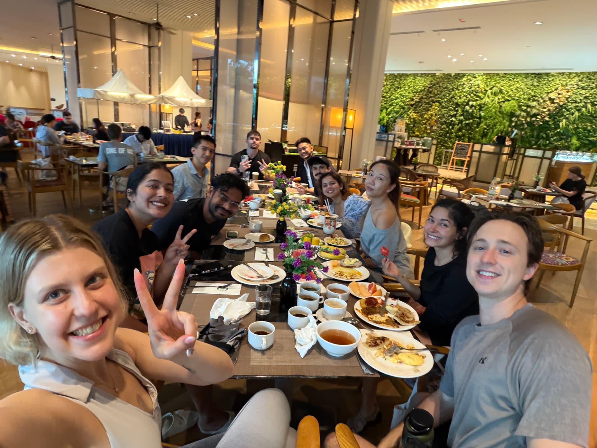 Tarannum with a team around a long breakfast table